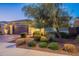 Night view of the home's exterior and landscaping at 27648 N 102Nd Ln, Peoria, AZ 85383