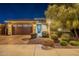 Attractive single-story home with landscaped front yard at night at 27648 N 102Nd Ln, Peoria, AZ 85383