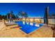 Stunning pool with lounge chairs and patio umbrellas at night at 27648 N 102Nd Ln, Peoria, AZ 85383