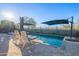 Bright and sunny pool area with lounge chairs and umbrellas at 27648 N 102Nd Ln, Peoria, AZ 85383