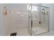 Clean and modern walk-in shower with glass enclosure at 27648 N 102Nd Ln, Peoria, AZ 85383