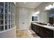 Spa-like bathroom with double vanities, a large mirror, and a glass block shower at 280 N 159Th St, Gilbert, AZ 85234