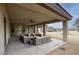 Spacious covered patio with seating area, ceiling fans, and views of the backyard at 280 N 159Th St, Gilbert, AZ 85234