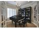 Music room featuring a grand piano and built-in shelving at 280 N 159Th St, Gilbert, AZ 85234