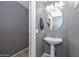 Updated powder room features pedestal sink and gray walls at 28025 N 23Rd Dr, Phoenix, AZ 85085