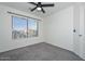 Bright bedroom with ceiling fan and large window at 28025 N 23Rd Dr, Phoenix, AZ 85085