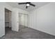 Bedroom with mirrored closet doors and ceiling fan at 28025 N 23Rd Dr, Phoenix, AZ 85085