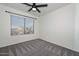 Bright bedroom with ceiling fan and large window at 28025 N 23Rd Dr, Phoenix, AZ 85085