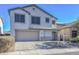 Two-story house with beige exterior, two-car garage, and landscaping at 28025 N 23Rd Dr, Phoenix, AZ 85085