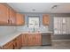 Modern kitchen features light wood cabinets, stainless steel appliances, and gray tile backsplash at 28025 N 23Rd Dr, Phoenix, AZ 85085