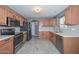 Modern kitchen with light wood cabinets and stainless steel appliances at 28025 N 23Rd Dr, Phoenix, AZ 85085