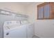 Laundry room with side-by-side washer and dryer and overhead shelving at 28025 N 23Rd Dr, Phoenix, AZ 85085