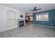 Living room with fireplace and teal accent wall at 28025 N 23Rd Dr, Phoenix, AZ 85085