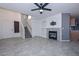 Living room with fireplace, grey tile floors, and a staircase at 28025 N 23Rd Dr, Phoenix, AZ 85085