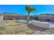 Relaxing kidney-shaped pool surrounded by a gravel patio and landscaping at 28025 N 23Rd Dr, Phoenix, AZ 85085