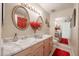 Bathroom with double sinks, marble countertop, and decorative mirrors at 2935 W Kristal Way, Phoenix, AZ 85027