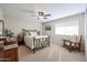 Bright bedroom with a vintage bed frame and an armchair at 2935 W Kristal Way, Phoenix, AZ 85027