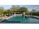 Inviting pool with a stone pergola and seating area at 29615 N 55Th Pl, Cave Creek, AZ 85331