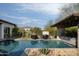 Resort-style pool, pergola, fire pit, and patio furniture at 29615 N 55Th Pl, Cave Creek, AZ 85331