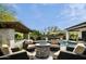 Outdoor living space featuring an in-ground pool, gas fire pit, and comfortable lounge chairs at 29615 N 55Th Pl, Cave Creek, AZ 85331