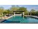 Beautiful in-ground pool with water feature, desert landscaping, and outdoor seating area at 29615 N 55Th Pl, Cave Creek, AZ 85331