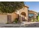 Tan house with stone accents, arched entryway, and landscaped yard at 31032 N Obsidian Dr, San Tan Valley, AZ 85143