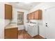 Laundry room with washer, dryer, cabinets, and wood-look floors at 31032 N Obsidian Dr, San Tan Valley, AZ 85143