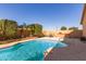 Beautiful backyard pool with patio furniture and lush landscaping at 31032 N Obsidian Dr, San Tan Valley, AZ 85143