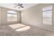 Bright bedroom with ceiling fan, carpet, and large windows at 3403 E Wyatt Way, Gilbert, AZ 85297