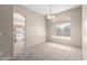 Spacious dining area with carpet and chandelier, open to kitchen at 3403 E Wyatt Way, Gilbert, AZ 85297