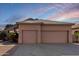 Tan two-story house with a two-car garage and desert landscaping at 3403 E Wyatt Way, Gilbert, AZ 85297