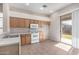 Kitchen features light wood cabinets, tile flooring and an adjacent patio at 3403 E Wyatt Way, Gilbert, AZ 85297