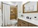 Clean bathroom with light wood vanity, white sink and a shower at 3611 E Kachina Dr, Phoenix, AZ 85044