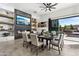 Modern dining room with large table, fireplace, and sliding doors to patio at 3611 E Kachina Dr, Phoenix, AZ 85044