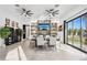 Modern dining room with large table, fireplace, and sliding doors to patio at 3611 E Kachina Dr, Phoenix, AZ 85044