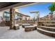 Circular fire pit with stone seating and landscaping at 3611 E Kachina Dr, Phoenix, AZ 85044