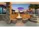 Stone fire pit with seating area in backyard at 3611 E Kachina Dr, Phoenix, AZ 85044