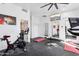 Home gym with Peloton bike and large mirror at 3611 E Kachina Dr, Phoenix, AZ 85044