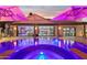 Large, illuminated pool with a spa and patio area at 3611 E Kachina Dr, Phoenix, AZ 85044