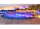 Luxury pool with spa and colorful night lighting at 3611 E Kachina Dr, Phoenix, AZ 85044