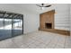 Living room with brick fireplace, built-in shelving, and sliding glass doors at 3645 E Shaw Butte Dr, Phoenix, AZ 85028