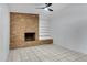 Bright living room featuring a brick fireplace and sliding glass doors to backyard at 3645 E Shaw Butte Dr, Phoenix, AZ 85028