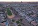 Aerial view of homes and a golf course at sunset at 3649 N Hudson Dr, Florence, AZ 85132