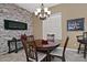 Bright dining room features a stone fireplace and wood table with seating for four at 3649 N Hudson Dr, Florence, AZ 85132