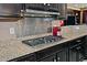 Stainless steel gas cooktop and modern backsplash in the kitchen at 3649 N Hudson Dr, Florence, AZ 85132