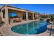 Inviting kidney-shaped pool with a waterfall feature and patio furniture at 3649 N Hudson Dr, Florence, AZ 85132