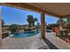 Inviting kidney shaped pool with a waterfall feature and patio furniture at 3649 N Hudson Dr, Florence, AZ 85132