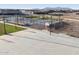 Aerial view of a community basketball court with benches nearby at 37053 W La Paz St, Maricopa, AZ 85138