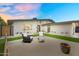 Relaxing backyard patio area with modern outdoor seating, green grass, and stylish exterior design at 3929 E Mercer Ln, Phoenix, AZ 85028