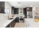 Modern kitchen with dark cabinetry and stainless steel appliances at 3929 E Mercer Ln, Phoenix, AZ 85028